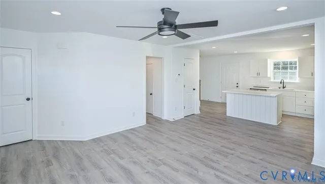 a view of a kitchen with a sink and a refrigerator