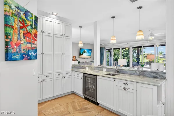 a kitchen with stainless steel appliances granite countertop a sink a stove a refrigerator and a window