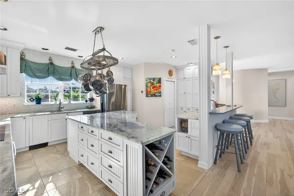 a kitchen with stainless steel appliances granite countertop a stove and refrigerator