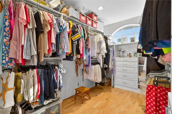 a view of walk in closet with clothes