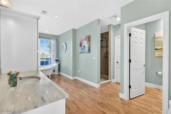 a kitchen with granite countertop a sink and a refrigerator