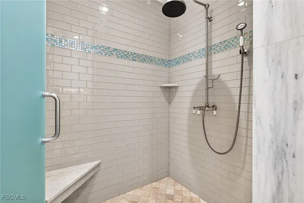 a bathroom with a glass shower door
