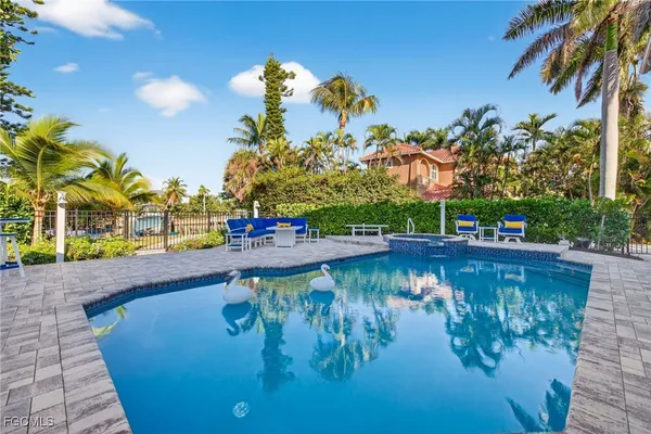 a view of swimming pool with chairs