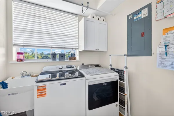 a kitchen with a stove a sink and a cabinets