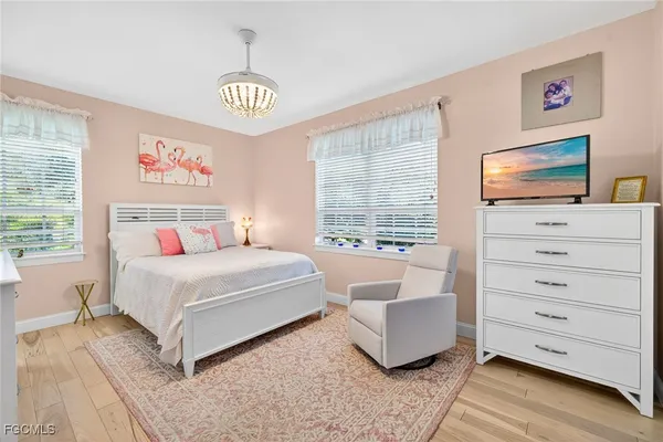 a bedroom with a bed a couch and a window