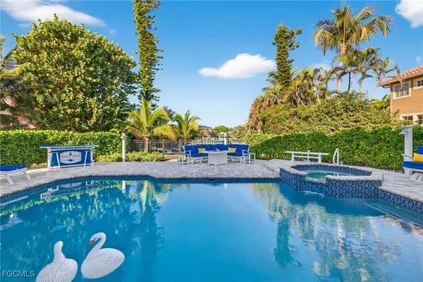 a view of a swimming pool with a patio and a yard