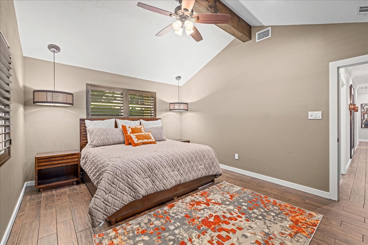 1502 Reimer Street Brenham, TX 77833 - Photo 16 of 30 a bedroom with a bed and wooden floor