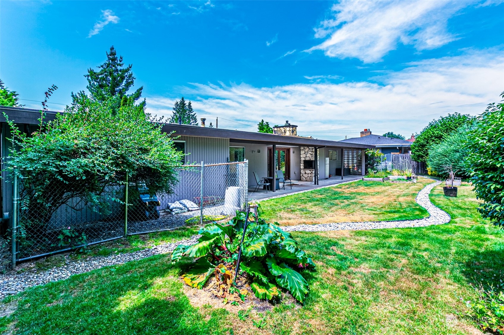 20462 98th Place South Kent, WA 98031 - Photo 23 of 31 a view of a house with a yard patio and a garden