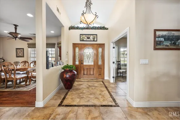 a living room with furniture a chandelier and a rug