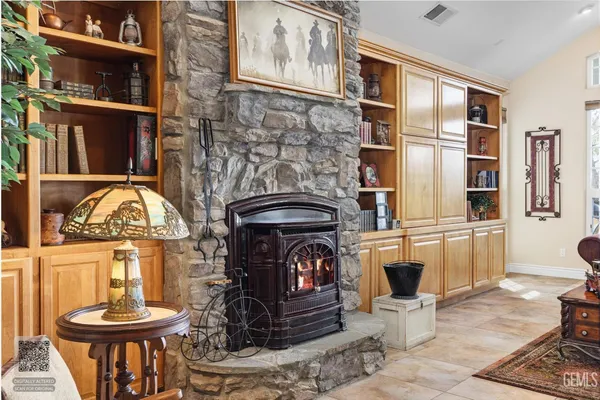 a kitchen with kitchen island granite countertop a sink a center island stainless steel appliances cabinets and a counter top space