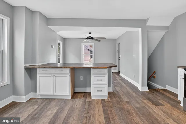 a view of a kitchen with a sink and a stove top oven