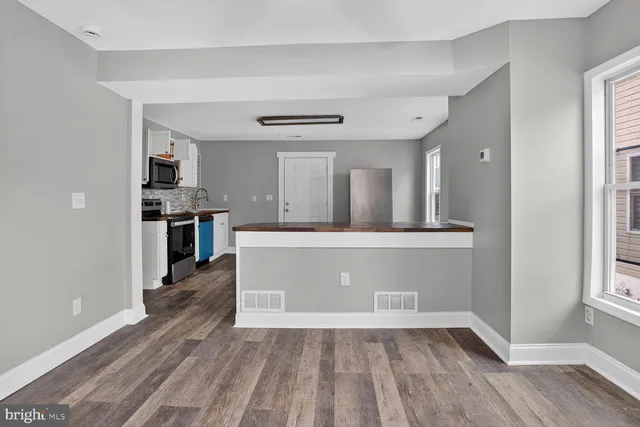wooden floor in kitchen and a room with wooden floor