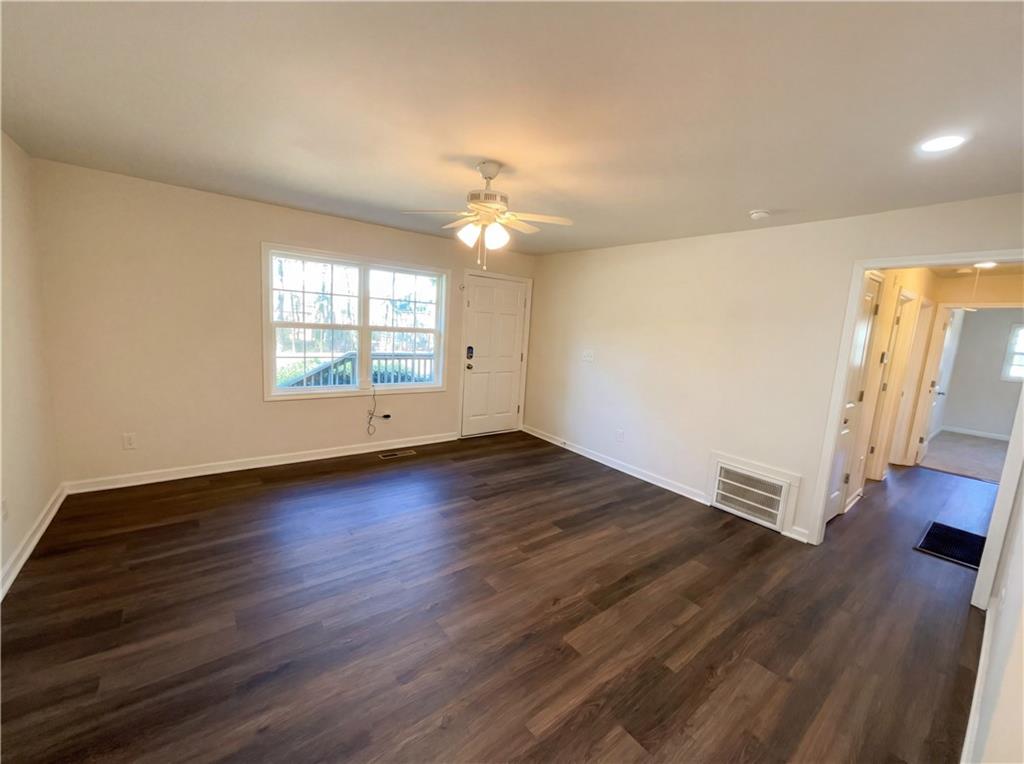 161 Grove Road Locust Grove, GA 30248 - Photo 3 of 18 a view of an empty room with wooden floor and a window