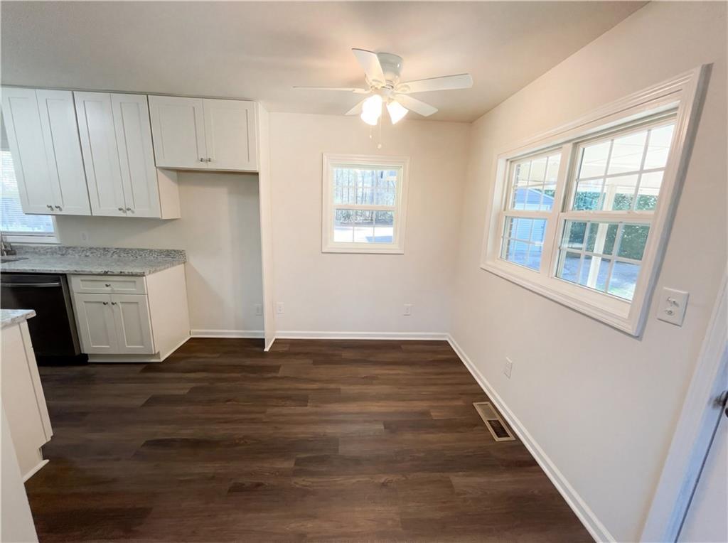 161 Grove Road Locust Grove, GA 30248 - Photo 8 of 18 a view of an empty room with window and wooden floor
