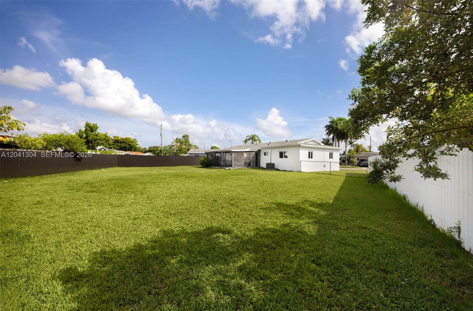 10340 Southwest 157th Street Miami, FL 33157 - Photo 21 of 24 Backyard – Expansive fenced backyard offering an impressive amount of open green space. Ideal for outdoor entertaining, recreation, gardening, or creating your own backyard oasis.