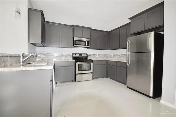 a kitchen with stainless steel appliances white cabinets and a sink