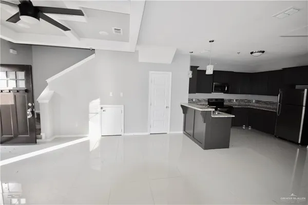 a view of kitchen with stainless steel appliances kitchen island