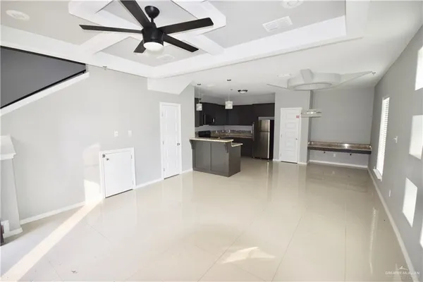 a view of a kitchen with a sink and a refrigerator
