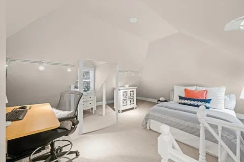 a living room with furniture a flat screen tv and a couch