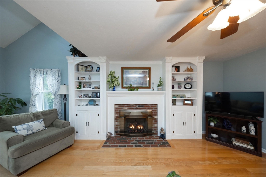 49 Dennis Whitney Road Oakham, MA 01068 - Photo 17 of 40 a living room with furniture a flat screen tv and a fireplace