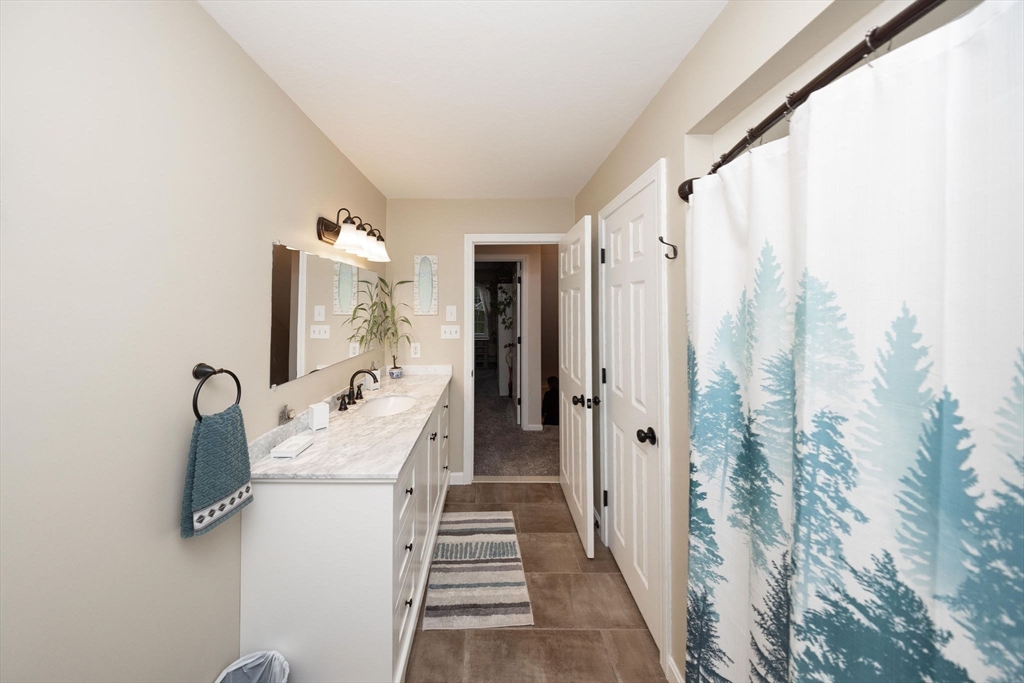 49 Dennis Whitney Road Oakham, MA 01068 - Photo 24 of 40 a hallway with white doors wooden floor and stairs