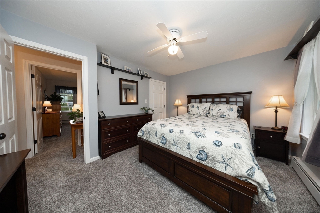 49 Dennis Whitney Road Oakham, MA 01068 - Photo 27 of 40 a bedroom with a bed and a chandelier