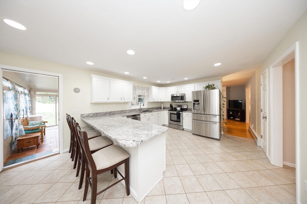 49 Dennis Whitney Road Oakham, MA 01068 - Photo 3 of 40 a kitchen with stainless steel appliances kitchen island granite countertop a sink and cabinets