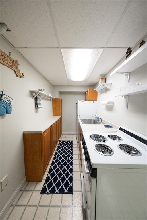49 Dennis Whitney Road Oakham, MA 01068 - Photo 32 of 40 a kitchen with a cabinets and stove top oven