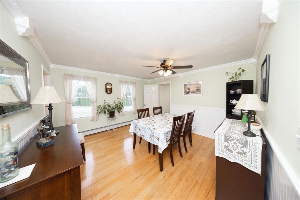 49 Dennis Whitney Road Oakham, MA 01068 - Photo 10 of 40 a living room with furniture dining table a lamp and a flat screen tv