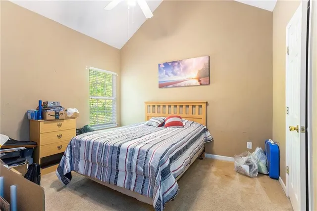 a bedroom with a bed and a window