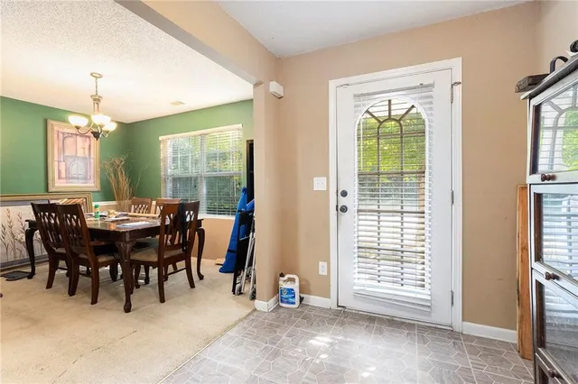 a view of a dining room with furniture and a chandelier