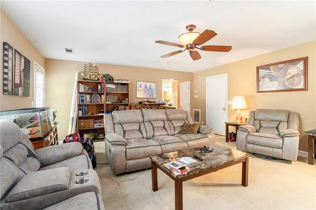 a living room with furniture a rug and a window
