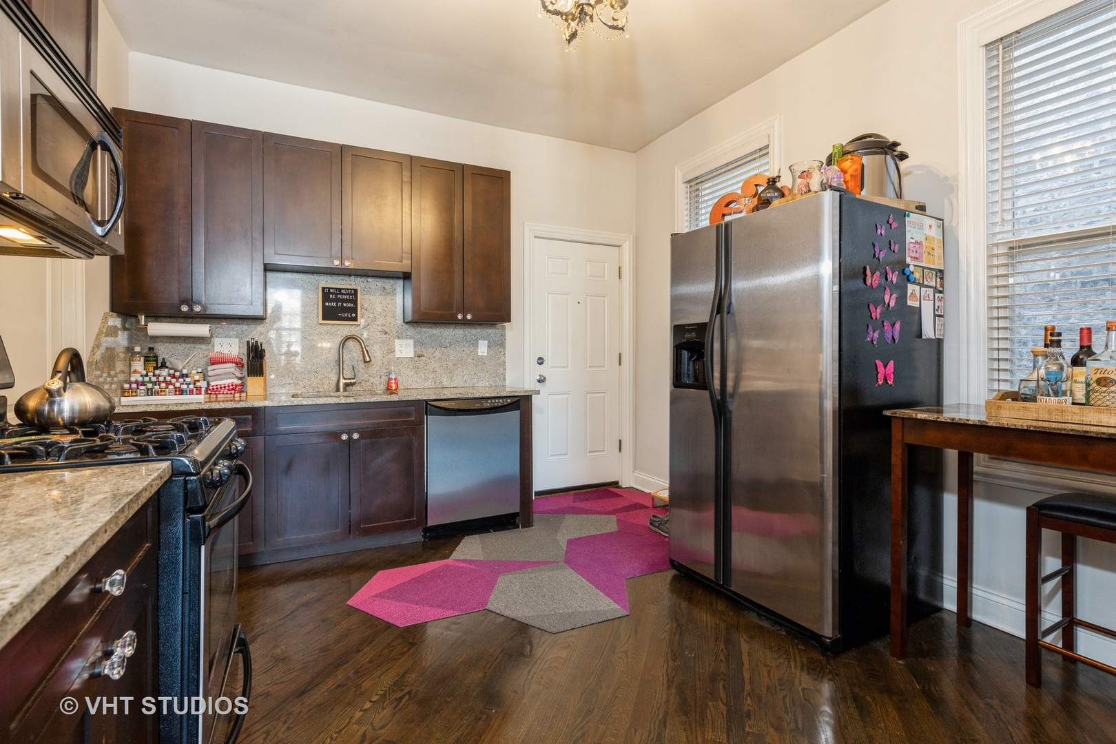 846 North Wolcott Avenue, Unit 2R Chicago, IL 60622 - Photo 6 of 12 a kitchen with stainless steel appliances granite countertop a refrigerator a sink dishwasher a stove with wooden cabinets and floor