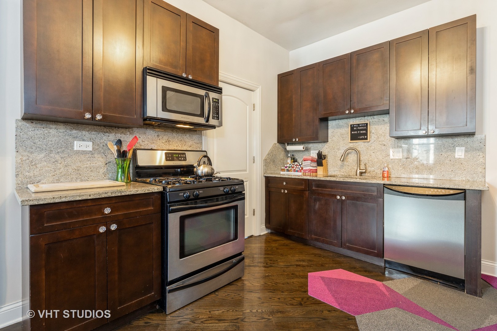 846 North Wolcott Avenue, Unit 2R Chicago, IL 60622 - Photo 7 of 12 a kitchen with stainless steel appliances granite countertop a stove a sink dishwasher and a microwave