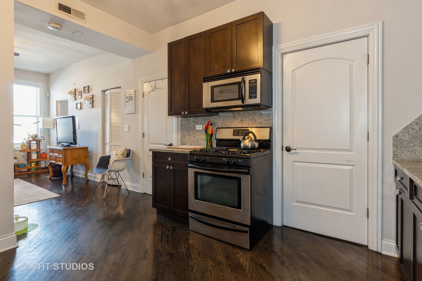846 North Wolcott Avenue, Unit 2R Chicago, IL 60622 - Photo 8 of 12 a kitchen with a refrigerator stove and wooden floor