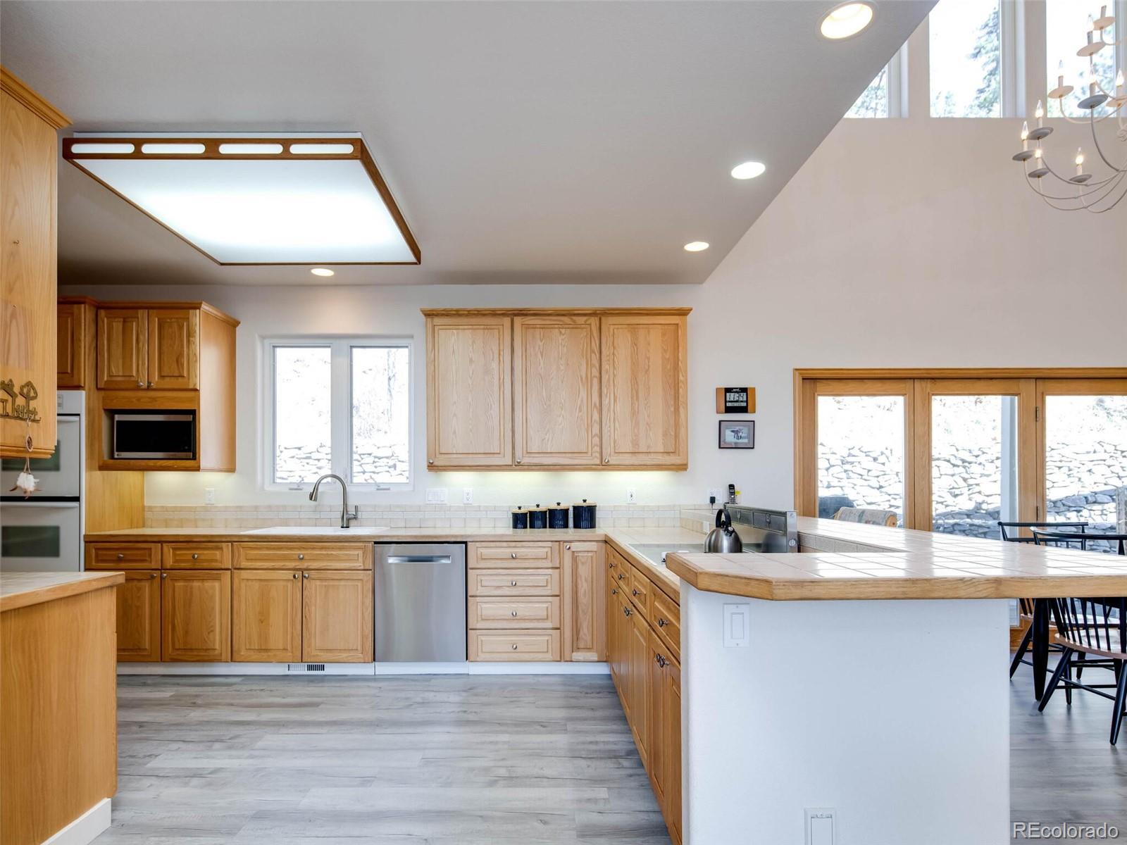 180 Nuthatch Road Evergreen, CO 80439 - Photo 13 of 40 a kitchen with lots of counter top space and dining table