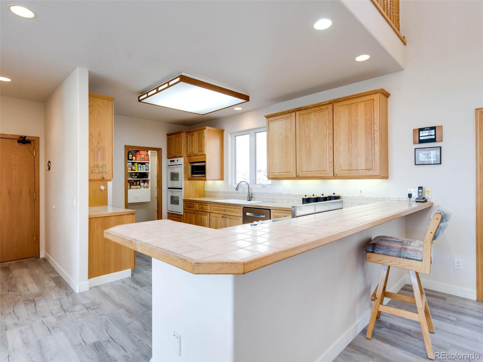 180 Nuthatch Road Evergreen, CO 80439 - Photo 15 of 40 a kitchen with stainless steel appliances granite countertop a sink a stove and a refrigerator