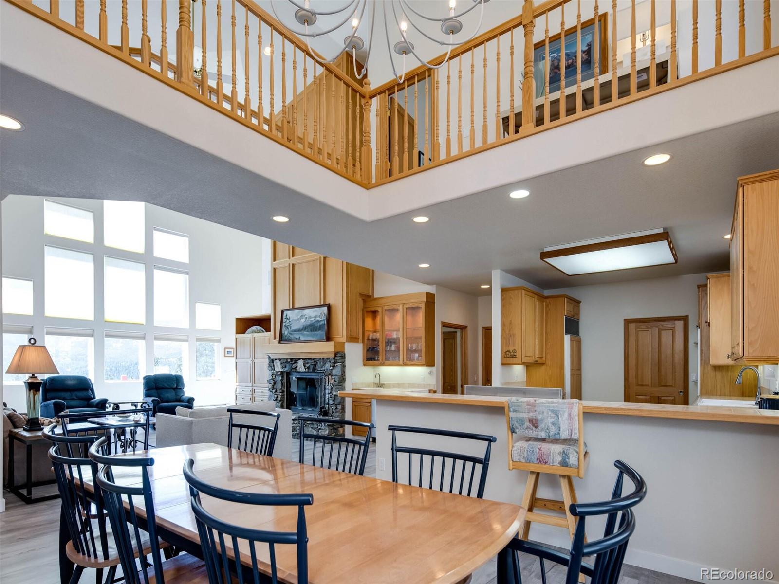 180 Nuthatch Road Evergreen, CO 80439 - Photo 16 of 40 a view of a dining room with furniture window and wooden floor