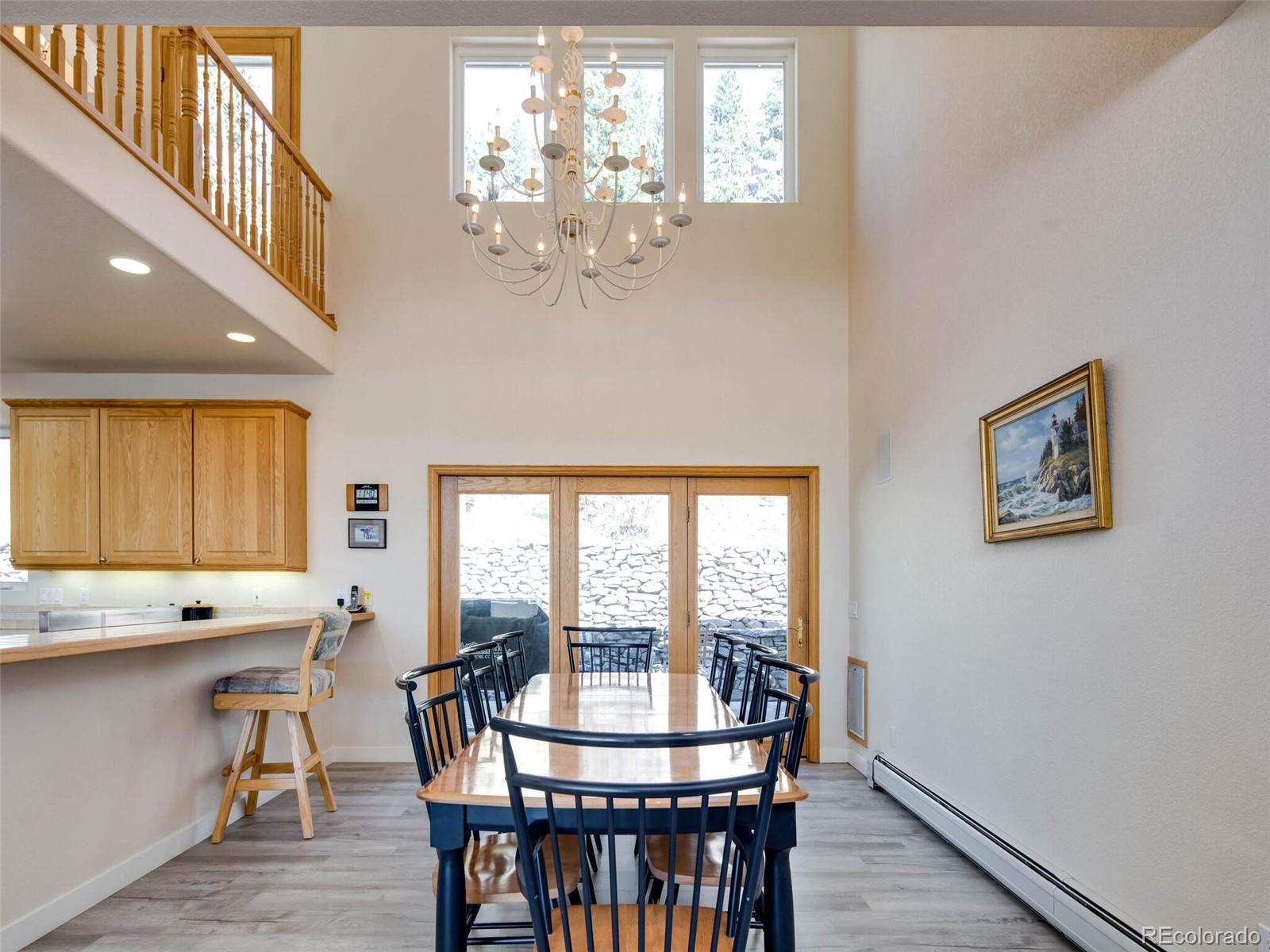 180 Nuthatch Road Evergreen, CO 80439 - Photo 17 of 40 a view of a dining room with furniture window and wooden floor