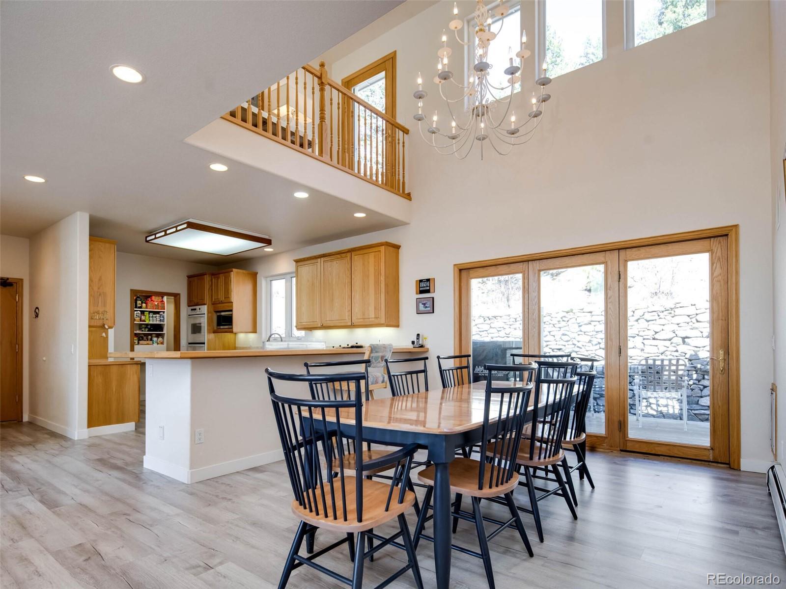 180 Nuthatch Road Evergreen, CO 80439 - Photo 18 of 40 a view of a dining room with furniture window and wooden floor