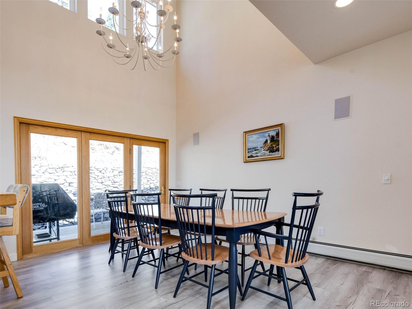180 Nuthatch Road Evergreen, CO 80439 - Photo 19 of 40 a view of a dining room with furniture wooden floor and chandelier