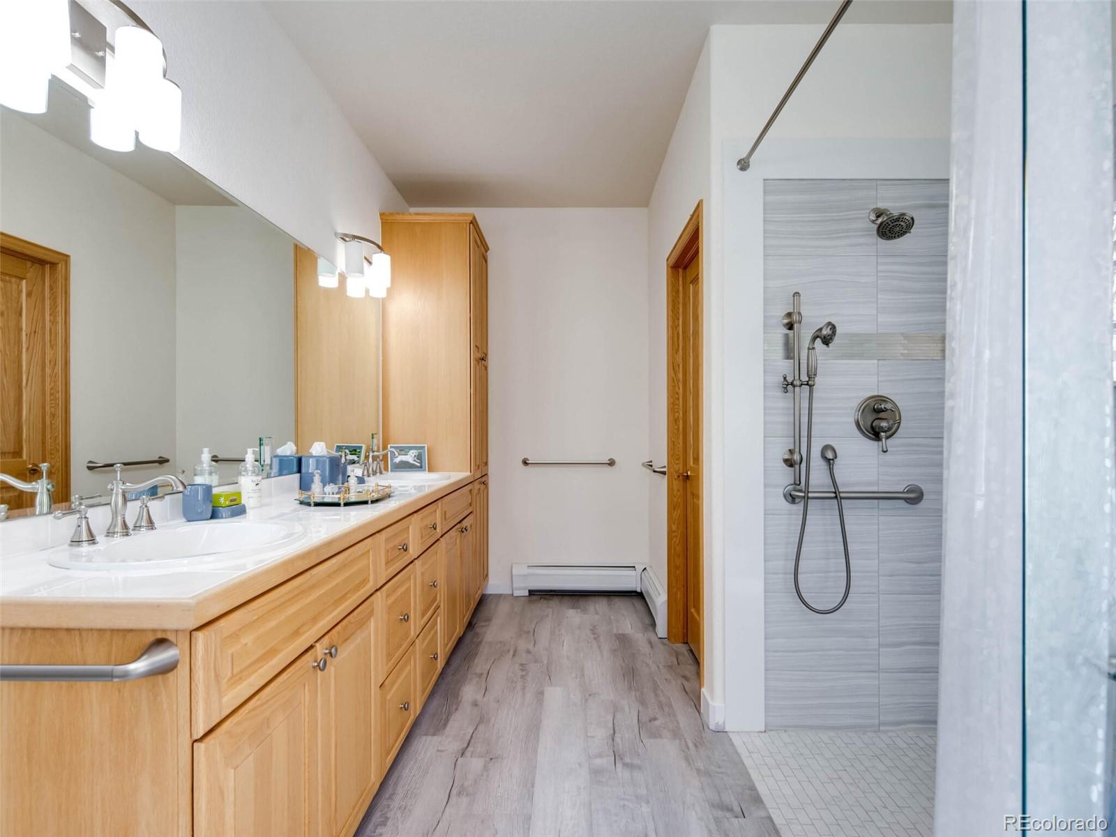 180 Nuthatch Road Evergreen, CO 80439 - Photo 25 of 40 a bathroom with a double vanity sink a mirror and shower