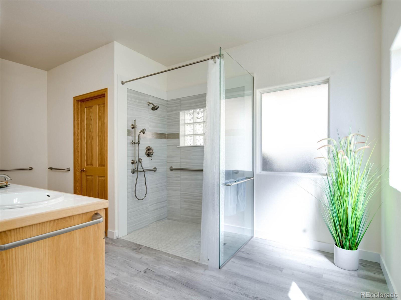 180 Nuthatch Road Evergreen, CO 80439 - Photo 27 of 40 a bathroom with a shower and a sink