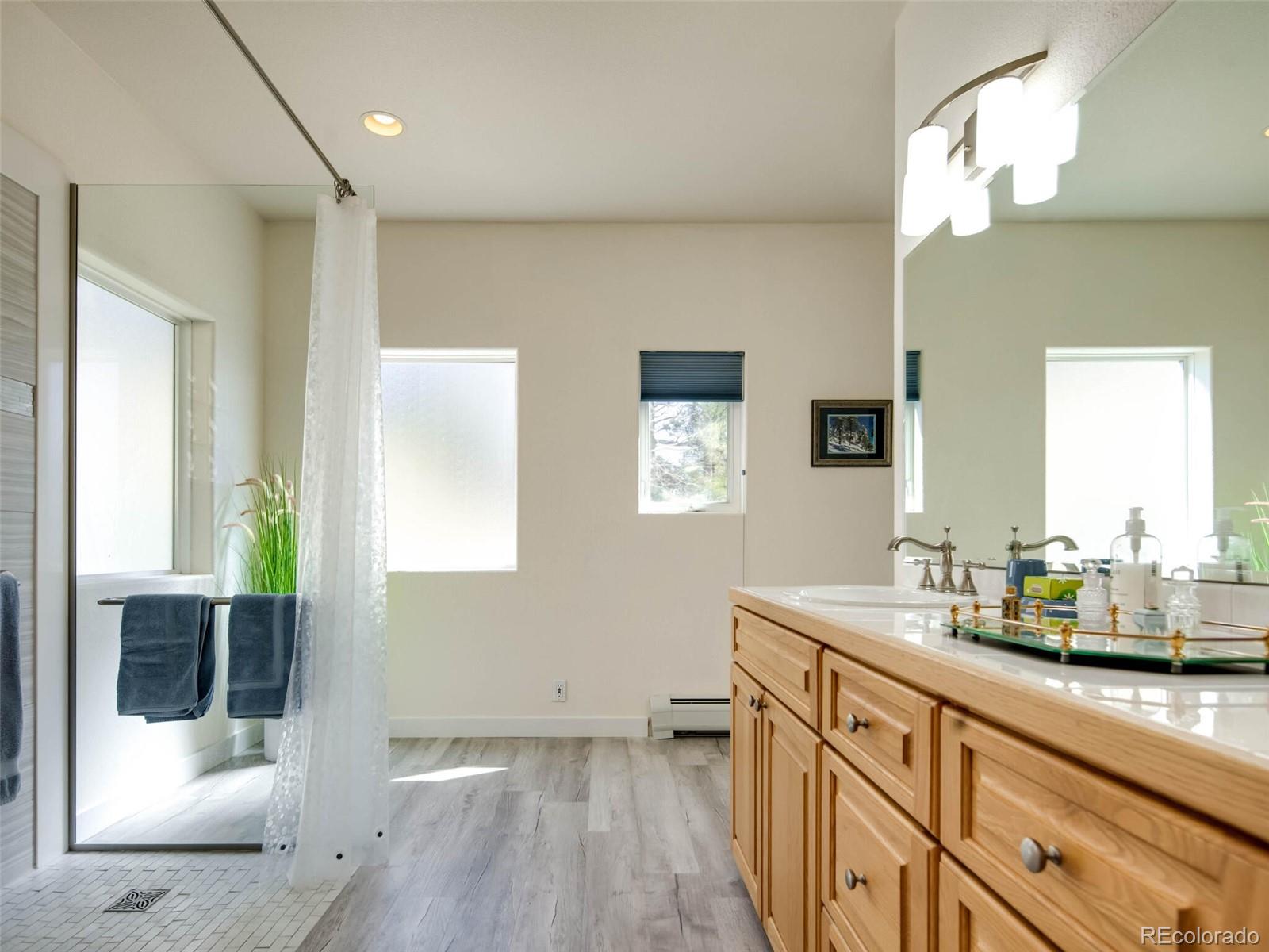 180 Nuthatch Road Evergreen, CO 80439 - Photo 28 of 40 a bathroom with a sink and a mirror