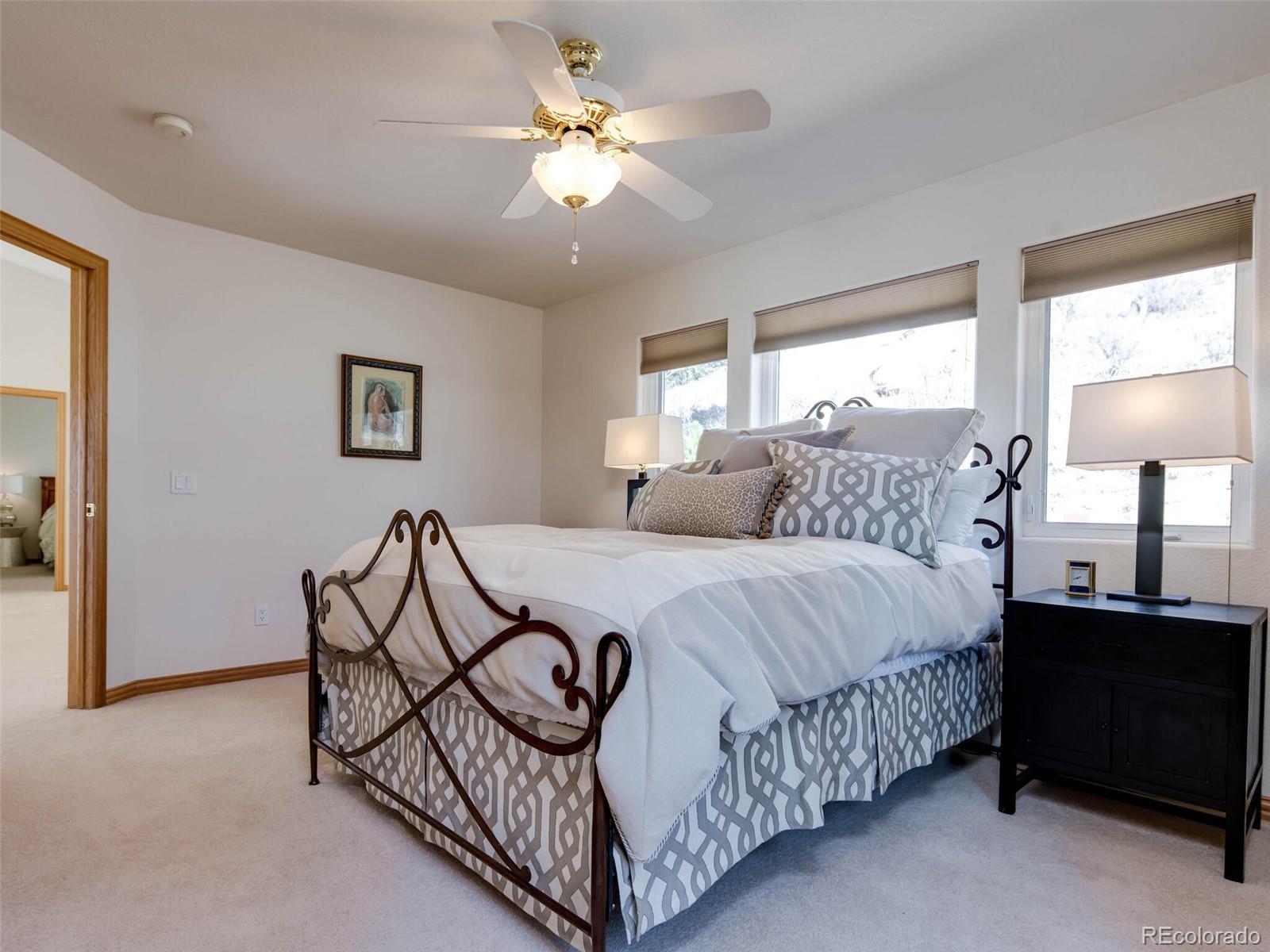 180 Nuthatch Road Evergreen, CO 80439 - Photo 32 of 40 a bedroom with a bed and a chandelier