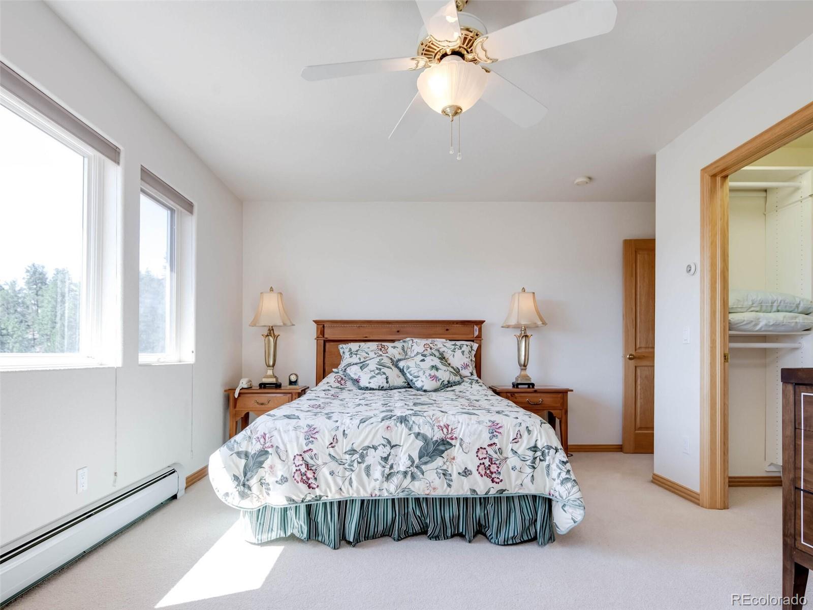 180 Nuthatch Road Evergreen, CO 80439 - Photo 35 of 40 a bedroom with a bed and a window