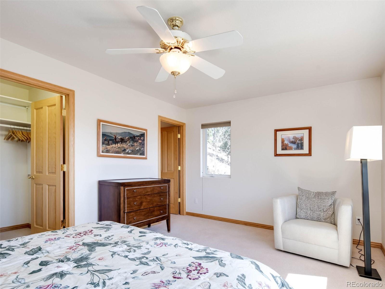180 Nuthatch Road Evergreen, CO 80439 - Photo 36 of 40 a bedroom with a bed and a dresser