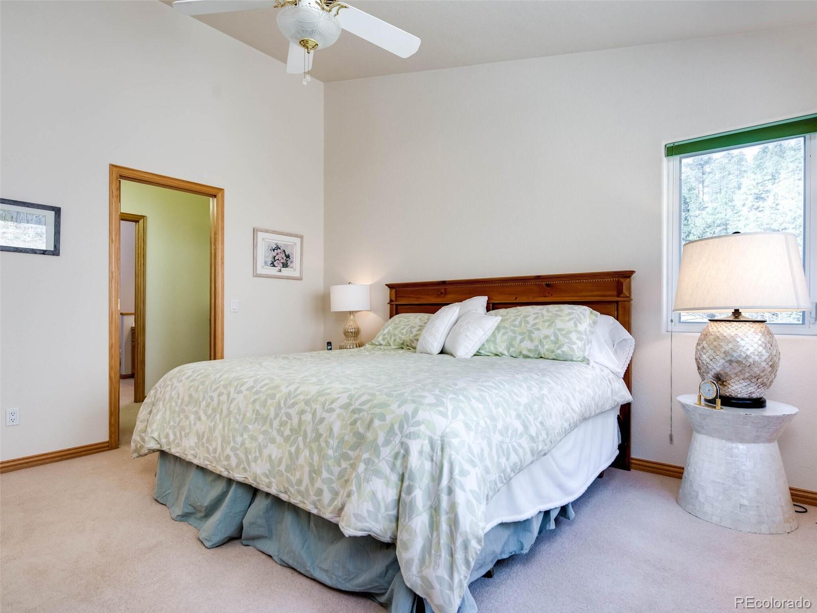 180 Nuthatch Road Evergreen, CO 80439 - Photo 39 of 40 a bedroom with a bed and window