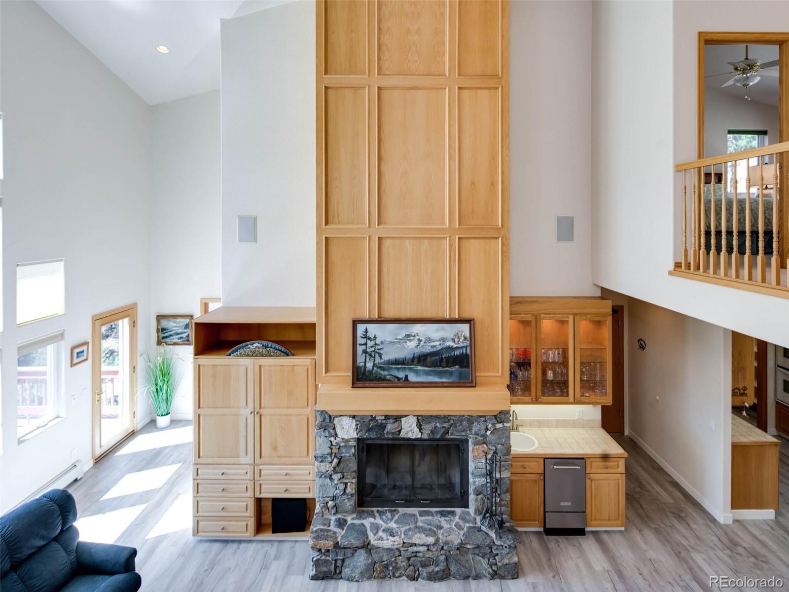 180 Nuthatch Road Evergreen, CO 80439 - Photo 6 of 40 a living room with furniture and a fireplace