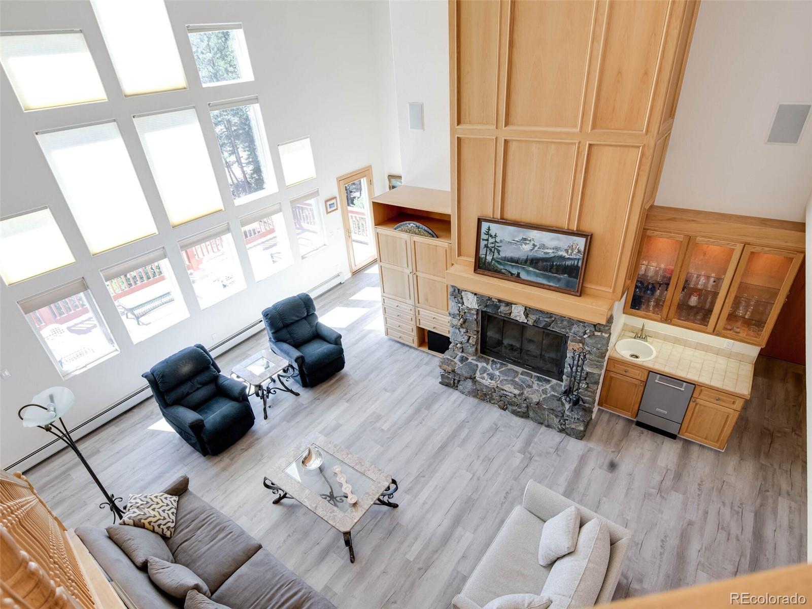 180 Nuthatch Road Evergreen, CO 80439 - Photo 7 of 40 a living room with furniture fireplace and a flat screen tv